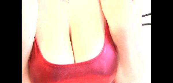  Busty babe in red latex rubbing her boobs